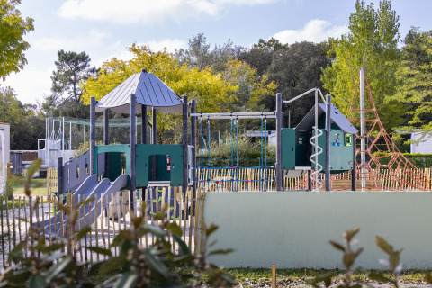 Parque infantil con toboganes y estructuras para trepar en Flower Camping La Davière Plage, Pays de la Loire, Francia.