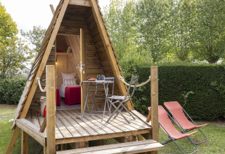 Acogedora cabaña Cabadienne en Flower Camping La Davière Plage en Francia, terraza y sillas exteriores.