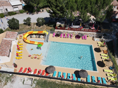 Aerial view of pool, loungers, water slide at Flower Camping La Rivière, Provence-Alpes-Côte d’Azur, France.