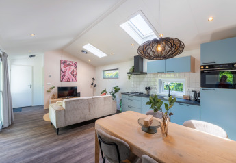 Bright, modern cottage interior with skylights, open kitchen, and stylish decor at De Thijmse Berg, Netherlands.