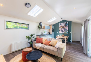 Modern wellness cottage at De Thijmse Berg, Netherlands, with cozy living area, kitchen, and natural light.