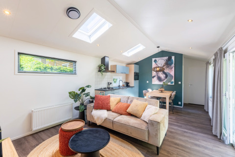 Modern wellness cottage at De Thijmse Berg, Netherlands, with cozy living area, kitchen, and natural light.