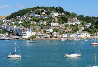 Scenic view of colorful houses and yachts in the harbor at Feather Down Fountain Violet Farm, South West England.
