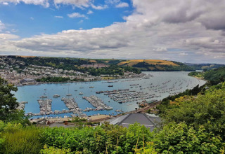 View of the river, marina, and lush valley from Feather Down Fountain Violet Farm in South West England.