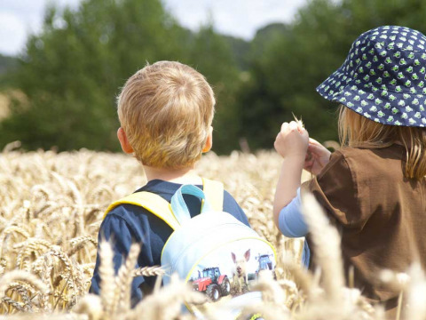 Twee kinderen ontdekken een graanveld bij Feather Down Manor Farm, vakantiepark in Zuidoost-Engeland, VK.
