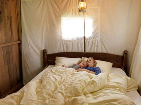 Zwei Personen schlafen gemütlich zusammen im Bett bei Feather Down L'Étable des Mauges en Anjou, Pays de la Loire.