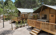 Tente safari Outback au camping Vilanova Park en Espagne, entourée d’arbres et d’un cadre naturel.
