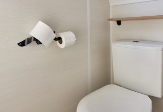 Compact bathroom with toilet and two toilet paper rolls on wall, Tiny Home Arrozal at TAIGA Delta de l'Ebre.