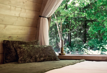 Acogedora cama en cabaña de madera con ventana abierta y vistas al bosque, Cabin at Thuysgrond, Países Bajos.