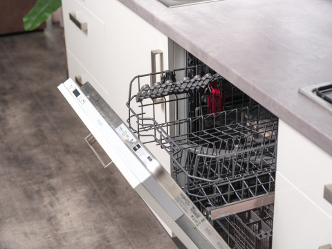 Opened dishwasher in a modern kitchen at River Cabin, Holiday Park Mölke, Netherlands, ready for dishes.