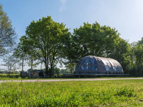 Modern Riverdome tiny house with bathroom and hot tub in green surroundings at Holiday Park Mölke, Netherlands
