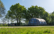 Modern Riverdome tiny house with bathroom and hot tub in green surroundings at Holiday Park Mölke, Netherlands