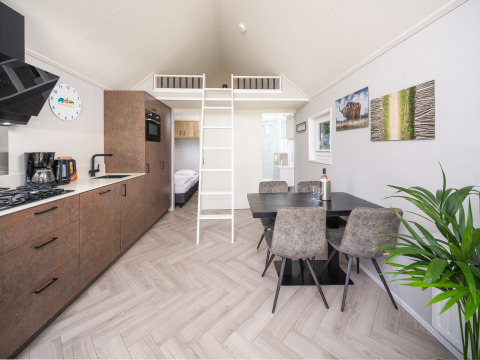 Cucina moderna e zona pranzo nella Summer Lodge al parco ricreativo e marina Rhederlaagse Meren, Paesi Bassi.