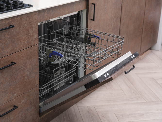 Open dishwasher with pulled-out rack in the kitchen at Summer Lodge, Rhederlaagse Meren, Netherlands.