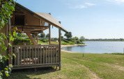 Safari tent Ranger by the lakeside at Recreation Park and Marina Rhederlaagse Meren in the Netherlands on a sunny day.