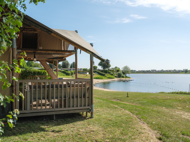 Safari tent Ranger by the lakeside at Recreation Park and Marina Rhederlaagse Meren in the Netherlands on a sunny day.