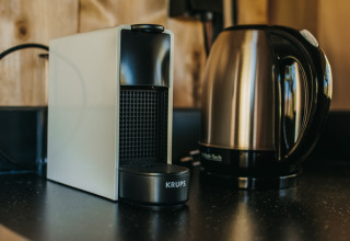 A photo of a coffee maker and electric kettle on a counter in a safari tent at Camping Lucherino, Italy.