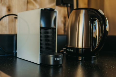 A photo of a coffee maker and electric kettle on a counter in a safari tent at Camping Lucherino, Italy.