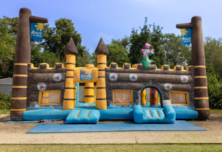 Inflatable bouncy castle for children at Flower Camping L'Ile d'Offard, Pays de la Loire, France, outdoors.