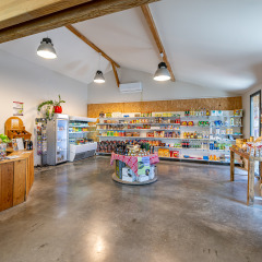 Bright, spacious shop with various groceries at Flower Camping Les Ondines holiday park in Occitanie, France.