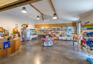 Bright, spacious shop with various groceries at Flower Camping Les Ondines holiday park in Occitanie, France.