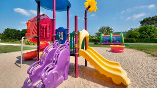 Colorful playground with slides and climbing frames at Flower Camping Les Ondines in Occitanie, France.