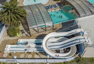 Aerial view of Flower Camping Cap Finistère holiday park in Brittany, France, featuring pools and waterslides.
