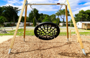 Net swing at the playground of Flower Camping Le Vieux Moulin, a holiday park in Brittany, France.
