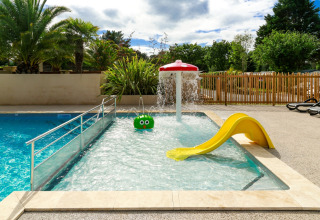 Children’s splash pool with slide and water play features at Flower Camping Le Vieux Moulin in Brittany, France.