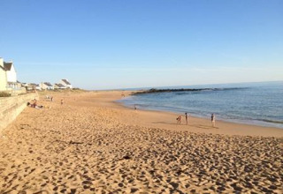 Sunny sandy beach at Flower Camping Les Paludiers holiday park in Pays de la Loire, France, by the sea.