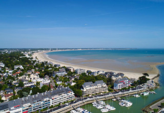 Aerial view of Flower Camping Les Paludiers holiday park with a beach and marina in Pays de la Loire, France.