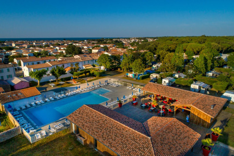Aerial view of Flower Camping Le Bel Air showing the pool, sun loungers, and vacation rentals in Nouvelle-Aquitaine, France.