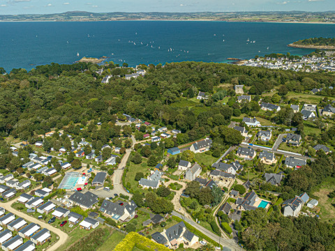 Vista aérea del parque de vacaciones Flower Camping Le Kerleyou en Bretaña, Francia, junto al mar y vegetación.