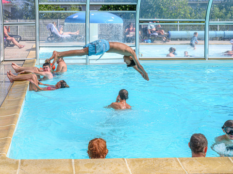 Kinder und Erwachsene genießen das Hallenbad im Flower Camping Le Kerleyou in der Bretagne, Frankreich.