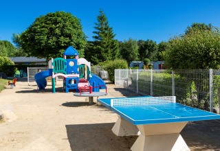 Spielplatz und Tischtennisplatte auf dem Flower Camping Le Kerleyou in der Bretagne, Frankreich.