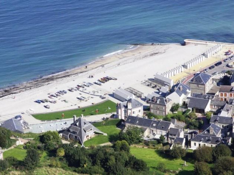 Aerial view of Flower Camping La Chênaie holiday park by the beach in Normandy, France, with sea nearby.