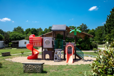 Playground with colorful slides at Flower Camping La Sagne holiday park in Nouvelle-Aquitaine, France.
