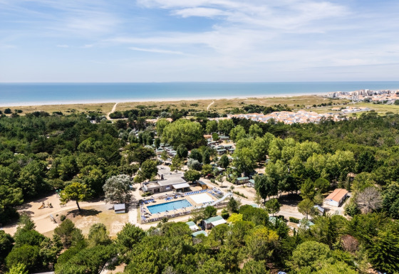 Aerial view of Camping Demoiselles Plage holiday park in Pays de la Loire, France, near forest and beach.