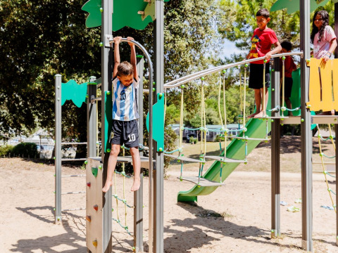 Children enjoy a modern playground at Camping Demoiselles Plage holiday park in Pays de la Loire, France.
