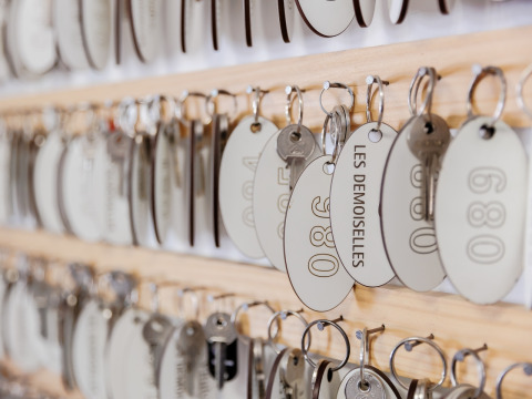 Keys with tags hanging on a board at Camping Demoiselles Plage holiday park in Pays de la Loire, France.