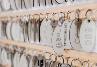 Keys with tags hanging on a board at Camping Demoiselles Plage holiday park in Pays de la Loire, France.