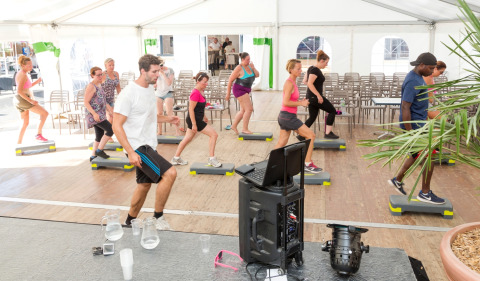 Step aerobics group class in a tent at Flower Camping Les Dunes, Pays de la Loire, France, holiday park.