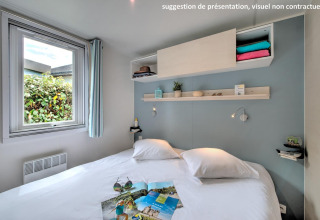 Moderne glamping slaapkamer met tweepersoonsbed, open raam, decoratieve planken en wit beddengoed.
