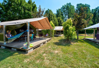 Tenda safari Freeflower Standard al Flower Camping Les Ondines in Francia, con veranda e amache esterne.