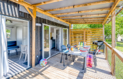 Houten terras met eetset en barbecue bij Homeflower Premium, Flower Camping Les Ondines, Frankrijk.