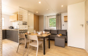 Modern living and dining space in a Stacaravan Premium at Flower Camping Le Vieux Moulin, France.