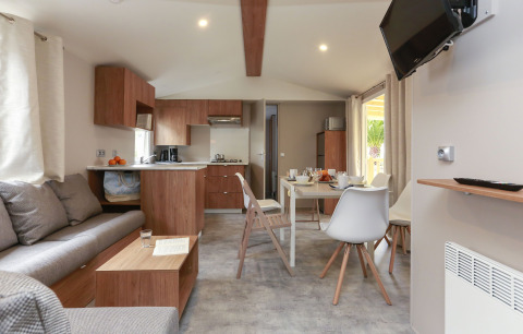 Sala y cocina modernas en Stacaravan Premium del Flower Camping Le Vieux Moulin en Francia.
