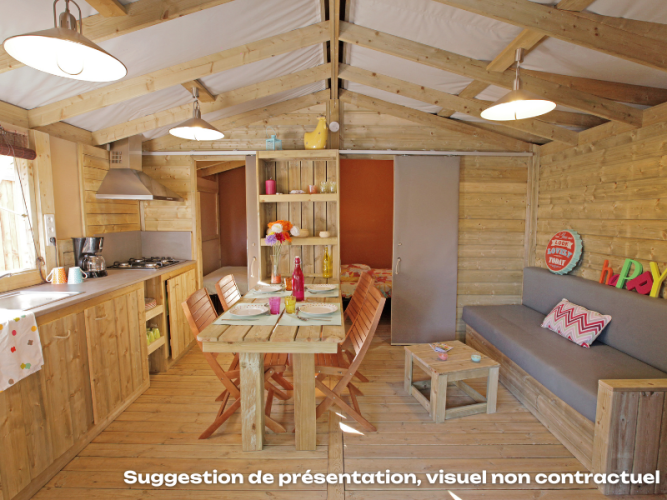 Bright, cozy interior view of CosyFlower Premium lodge at Flower Camping Mas de Champel, France.