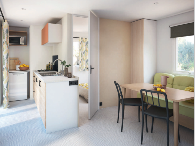 Moderne stacaravan met keuken, eethoek en zithoek op Flower Camping Mas de Champel in Frankrijk.