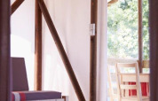 Inside view of a safari tent Cabane Lodge op palen Standard at Flower Camping Les Paludiers in France.